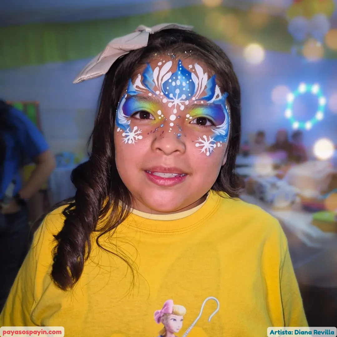 Niña con antifaz de Frozen y corona de reina de las nieves en azul y blanco con copos de nieve