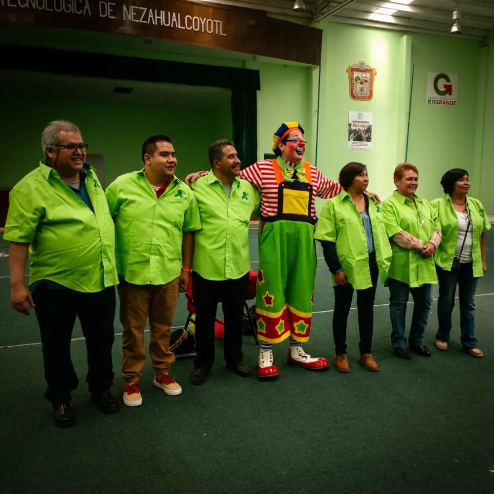 El Payaso Payín posa con un equipo de trabajo uniformado después de una dinámica de integración